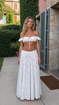Front view of model wearing white lace crop top and maxi skirt set
