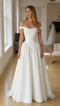 Front view of white off-the-shoulder drop-waist gown