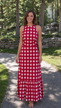 Front view of woman wearing red gingham maxi dress outdoors