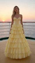 Model wearing yellow sweetheart corset tiered ruffle long evening gown, front view