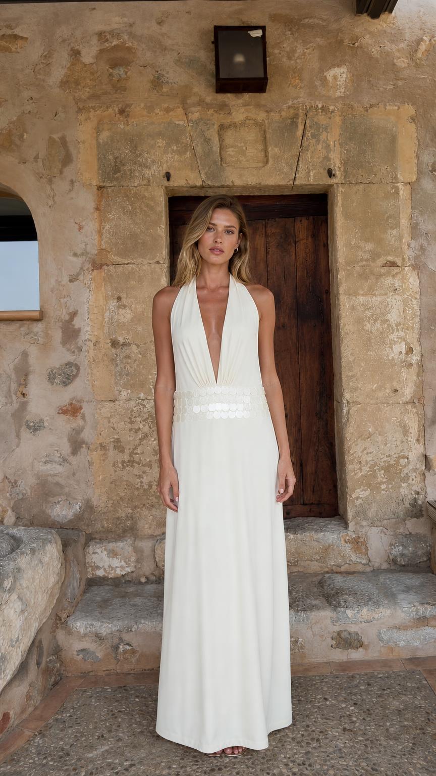 Front view of woman wearing white halter neck maxi dress