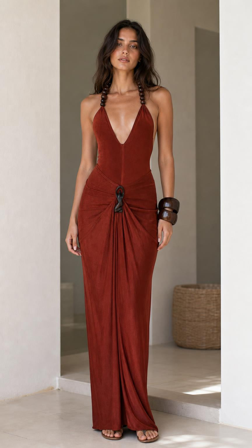 Model wearing rust halter maxi dress from the front