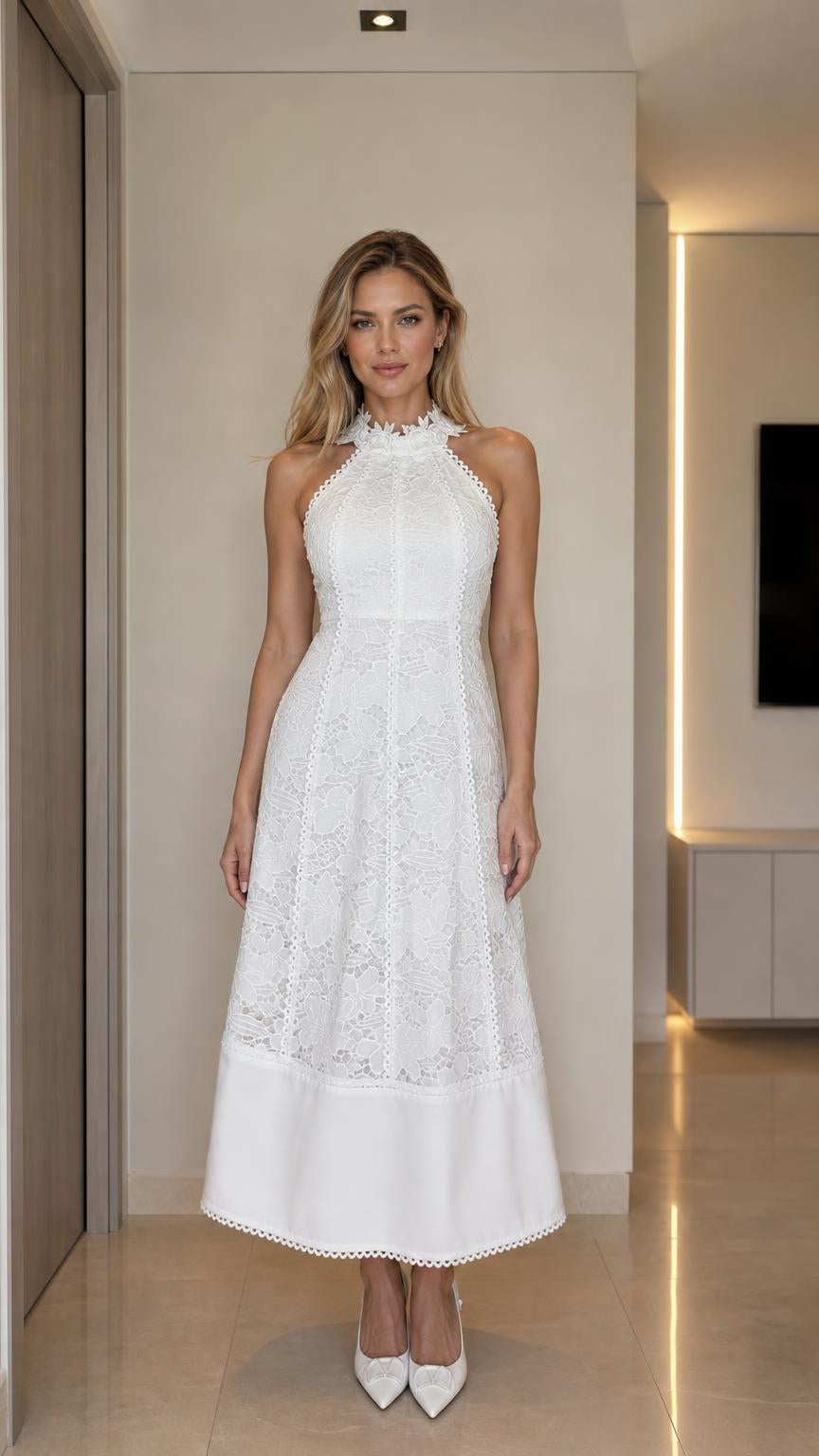 Front view of woman wearing white halter neck lace midi dress
