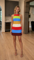 Front view of model wearing vibrant colorblock halter mini dress