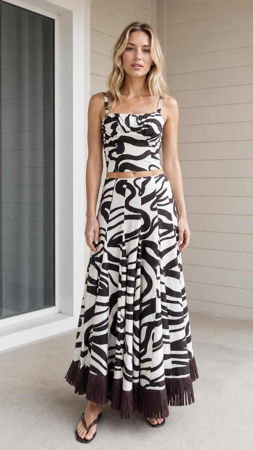 Front view of model wearing black and white zebra print crop top and maxi skirt set
