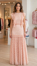 Model wearing pink ruffled maxi dress from front