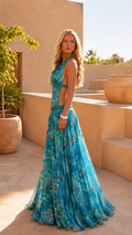 Side view of turquoise floral halter backless maxi dress with flowing skirt