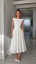 Front full view of woman wearing white boatneck midi dress