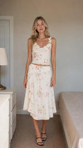 Front view of ivory floral two-piece set on model