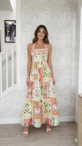 Front view of model wearing multi patchwork halter maxi dress