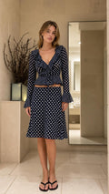 Front view of model wearing Navy Blue polka dot two piece set