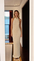 Model wearing cream mock neck sleeveless backless maxi knit dress from the front