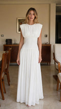 Front view of woman wearing white pleated maxi dress