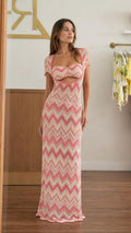 Front view of woman wearing pink chevron knit maxi dress