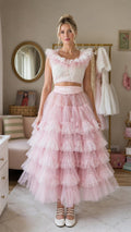 Front view of model wearing pink ruffled tulle two-piece dress