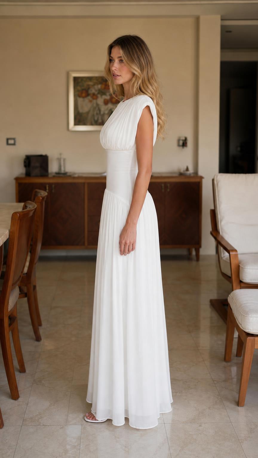 Side profile of woman in white maxi dress