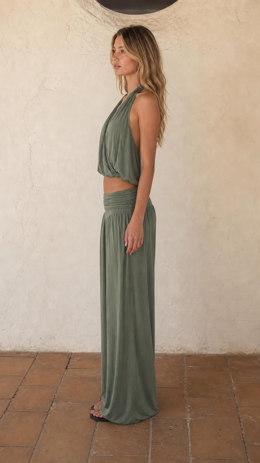 Side view of woman wearing sage green two-piece lounge set