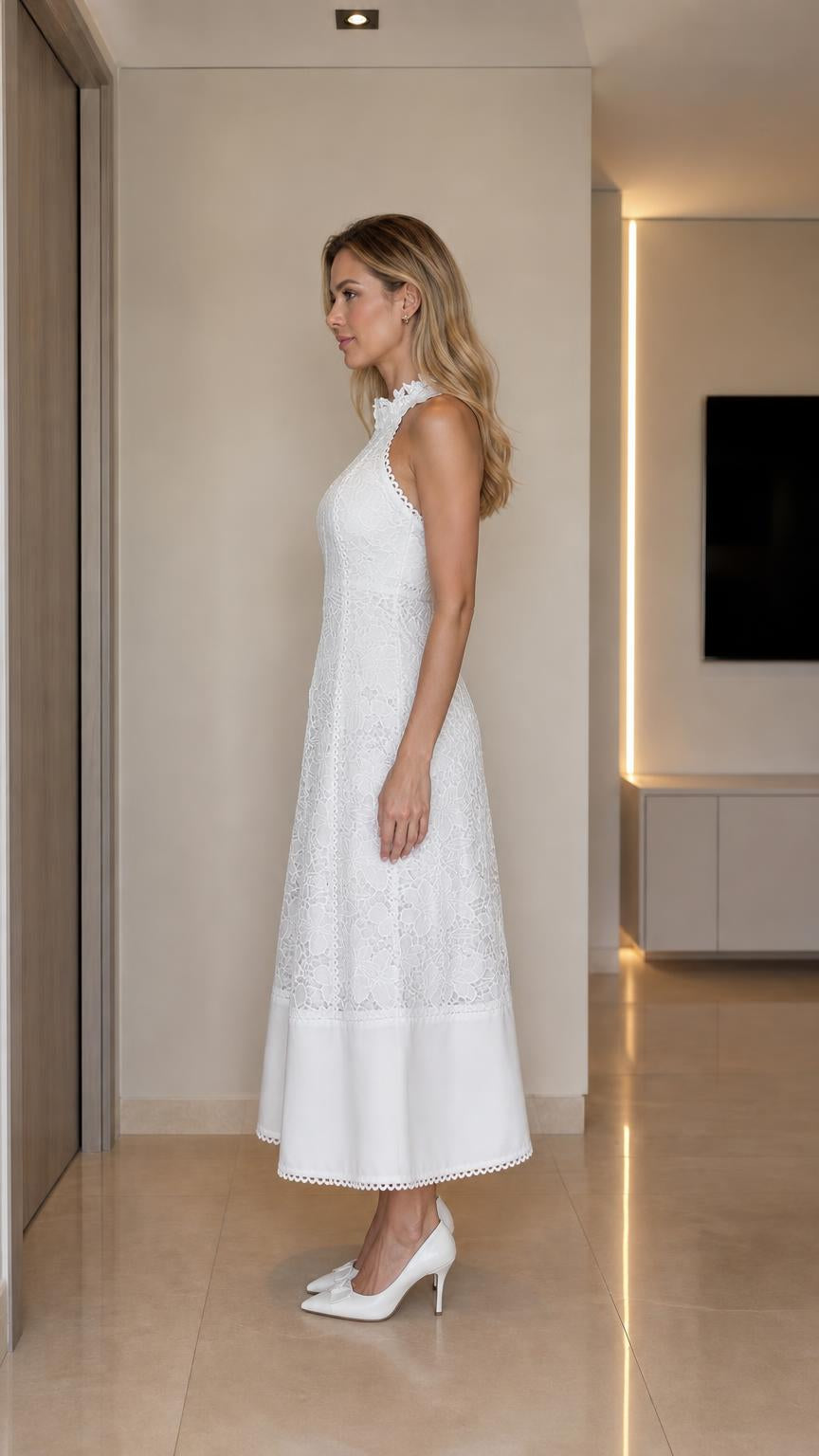 Side profile view of woman in white lace midi dress
