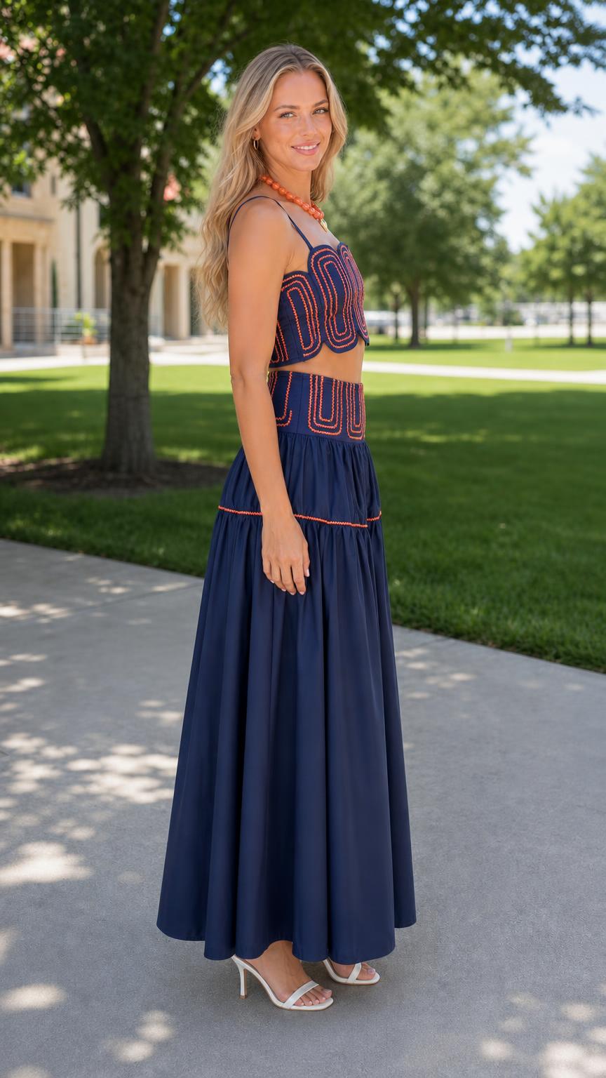 Side profile of woman in navy two-piece set with heels