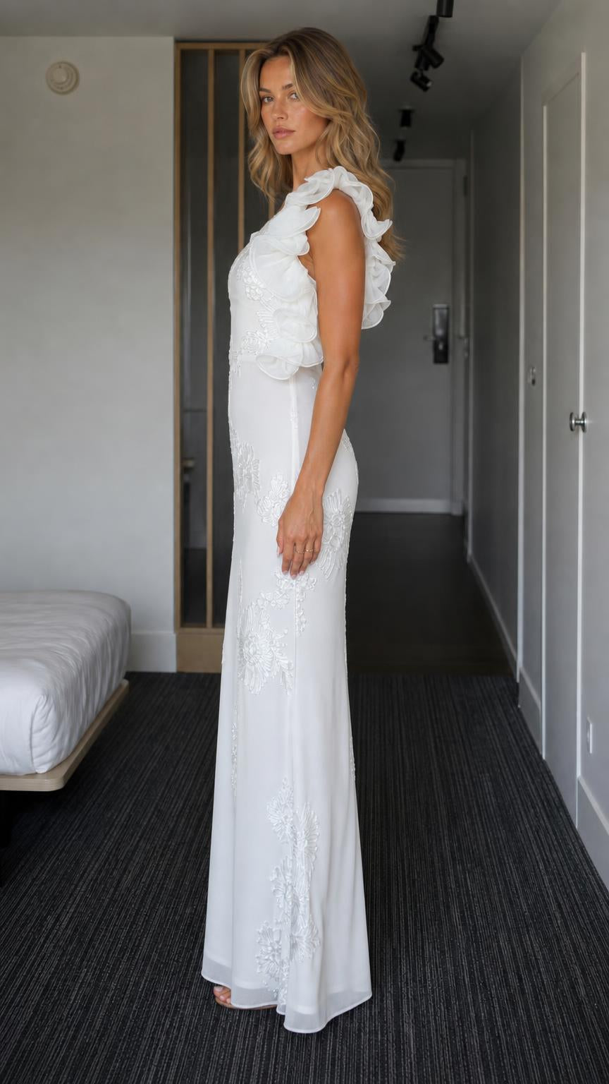 Side profile view of white one-shoulder gown