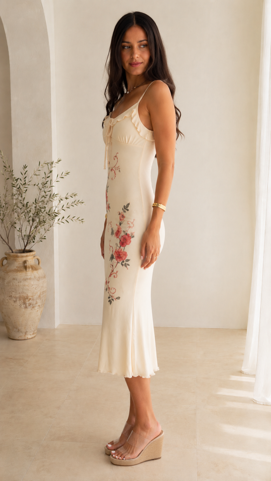 Side view of ivory floral print slip midi dress with slim straps and midi hem