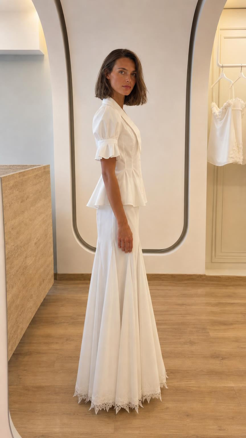 Side profile of woman in white matching peplum and skirt set
