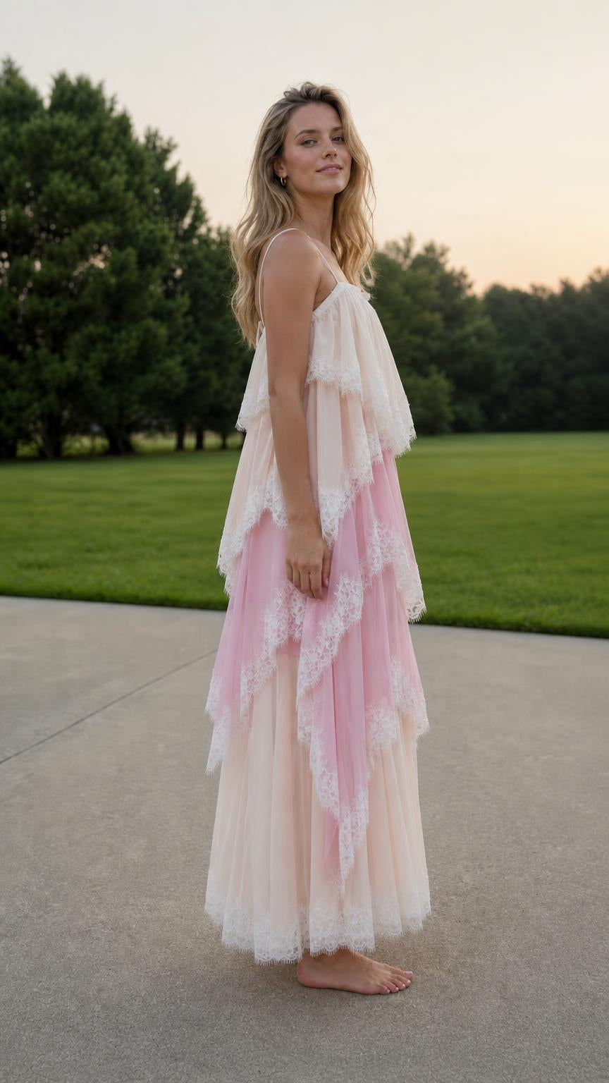 Side profile of model in multi pink layered dress
