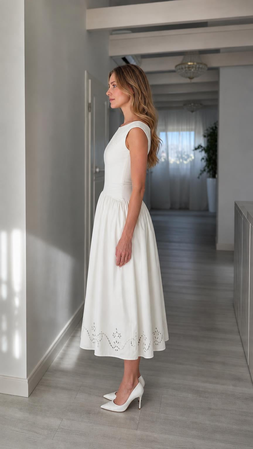 Side profile view of woman wearing white midi dress with heels