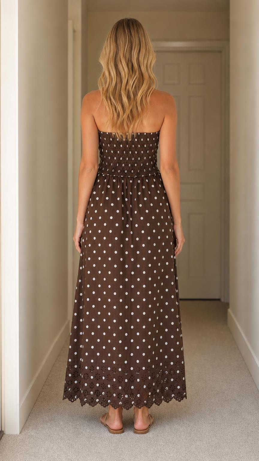 Back view of woman wearing brown polka dot maxi dress