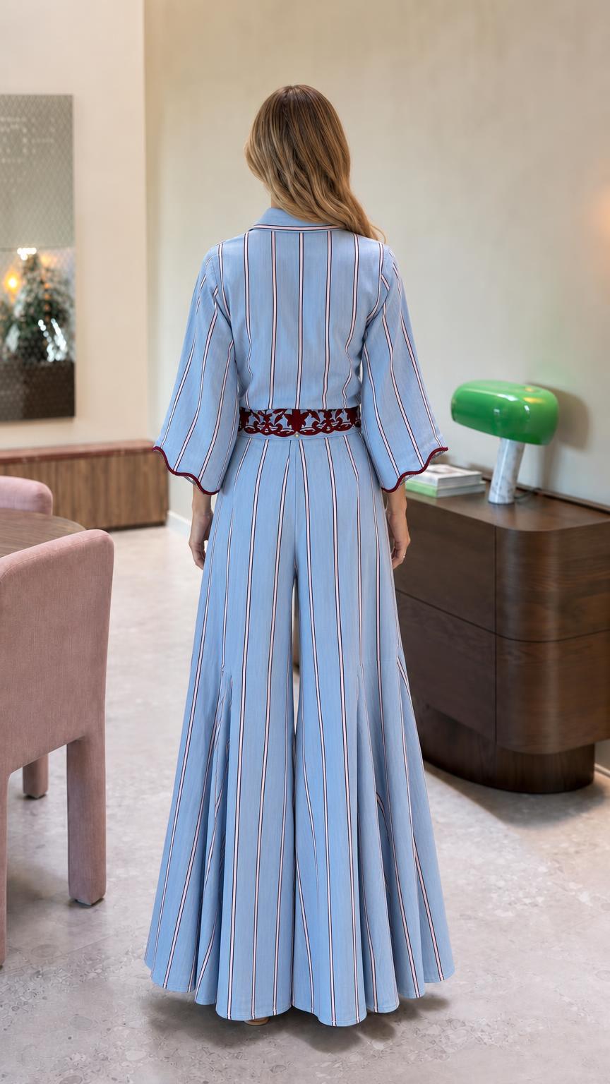 Back view of light blue striped jumpsuit with embroidered waist