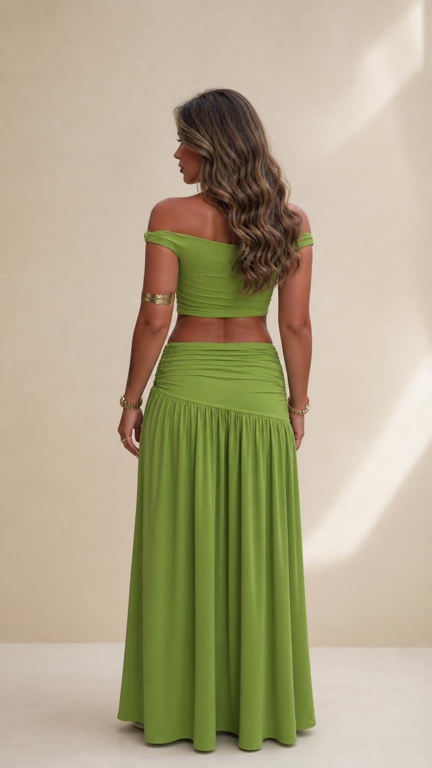 Back view of woman wearing olive green coordinating crop top and maxi skirt