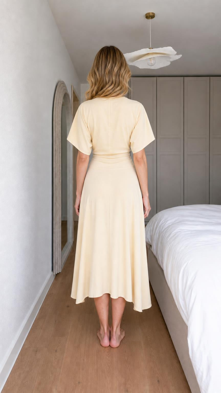 Back view of woman wearing yellow midi dress
