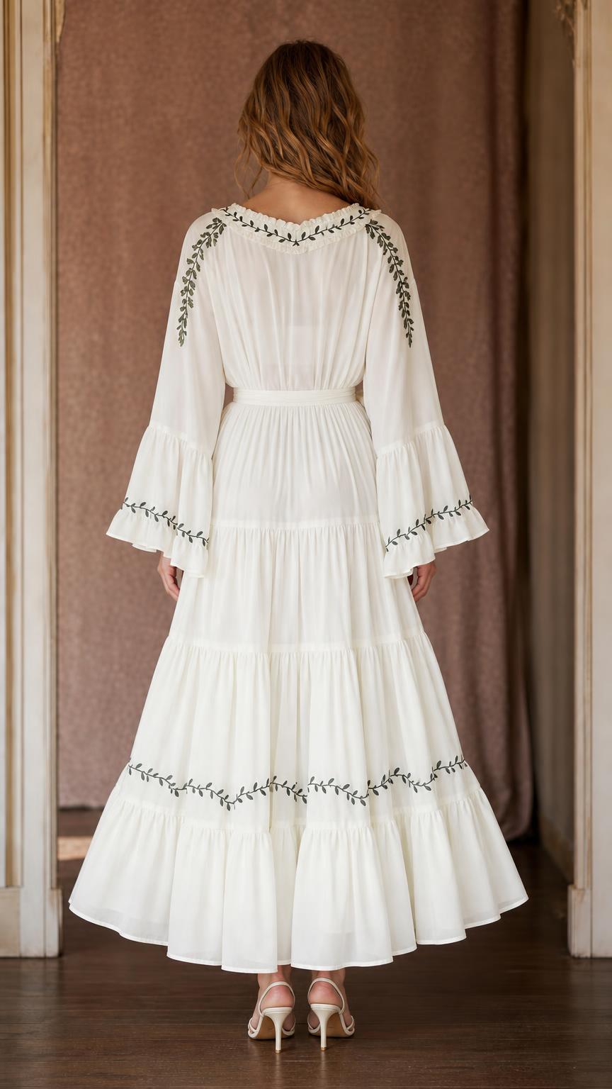 Back view of ivory tiered maxi dress with gathered waist, botanical trim, and ruffled hem