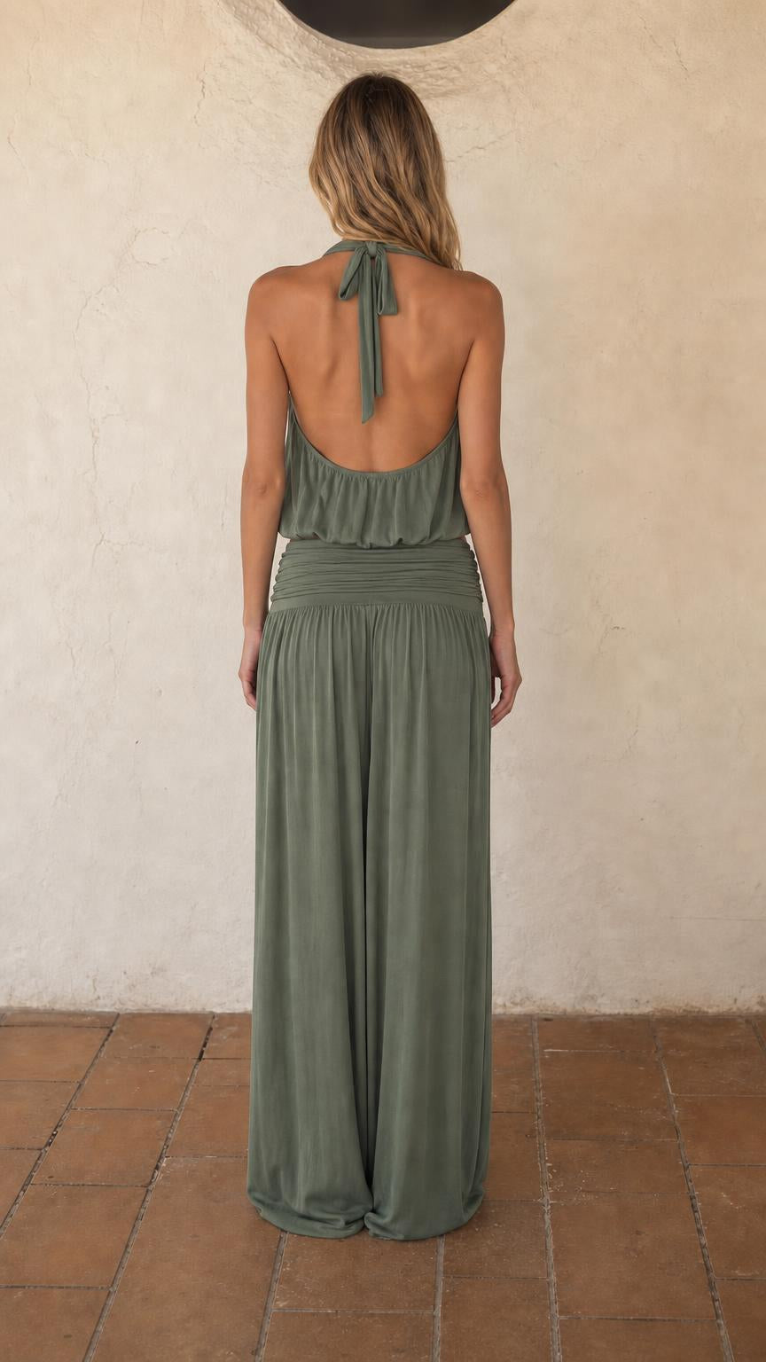 Back view of woman wearing sage green halter top and wide leg pants