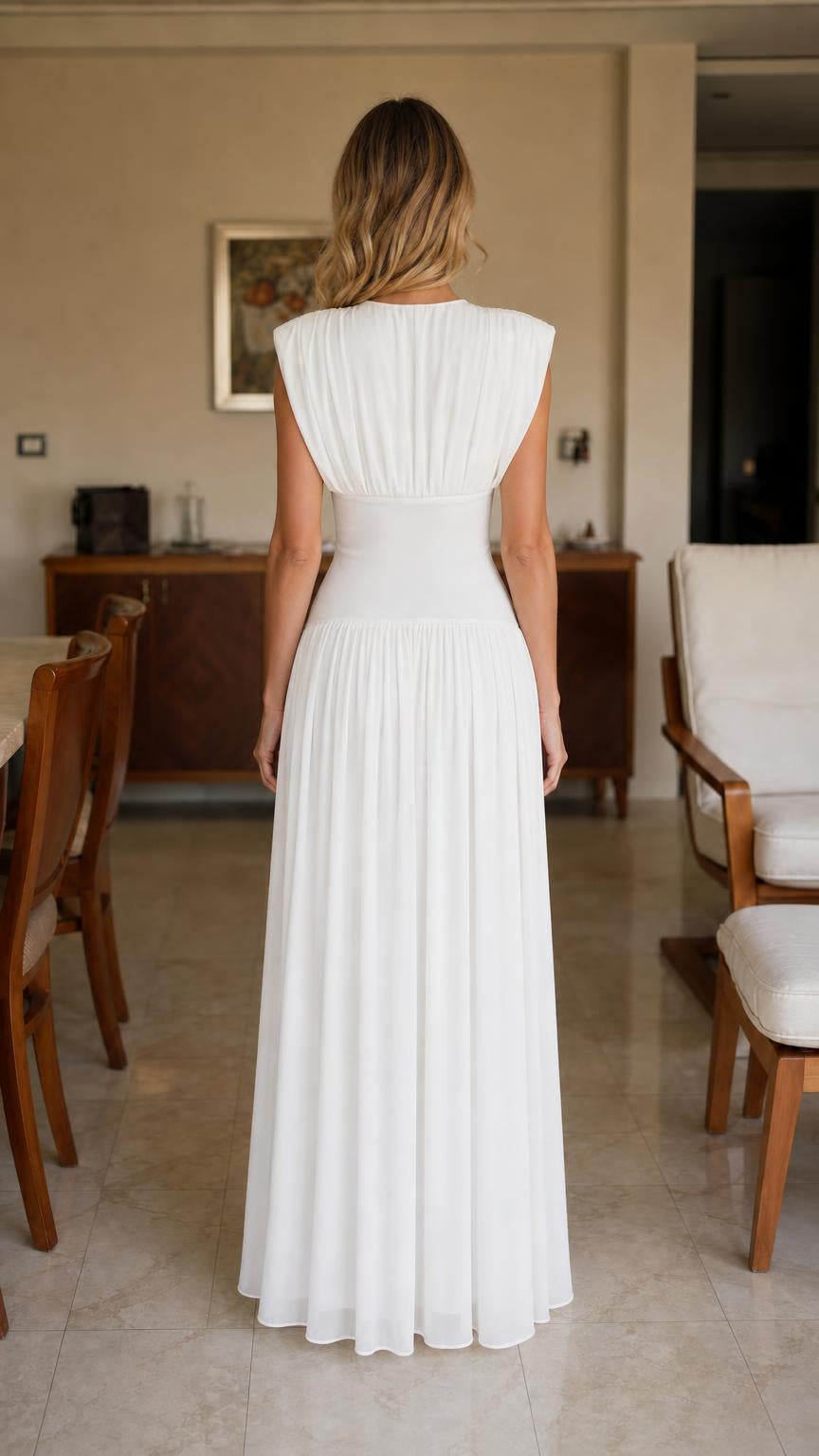 Back view of woman in white pleated maxi dress