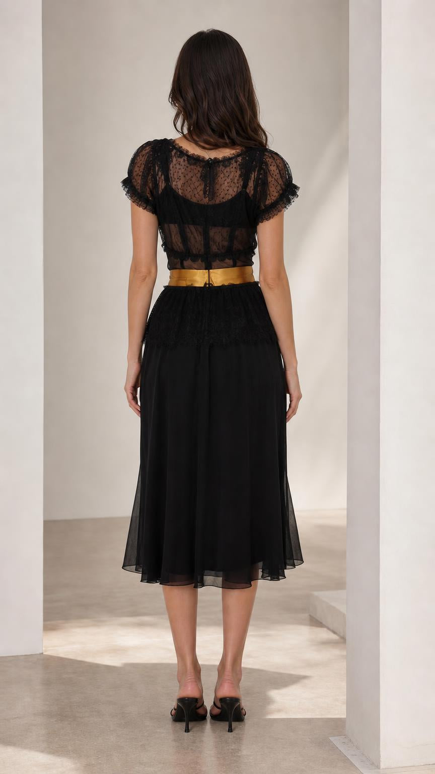Back view of black midi dress showing sheer lace back