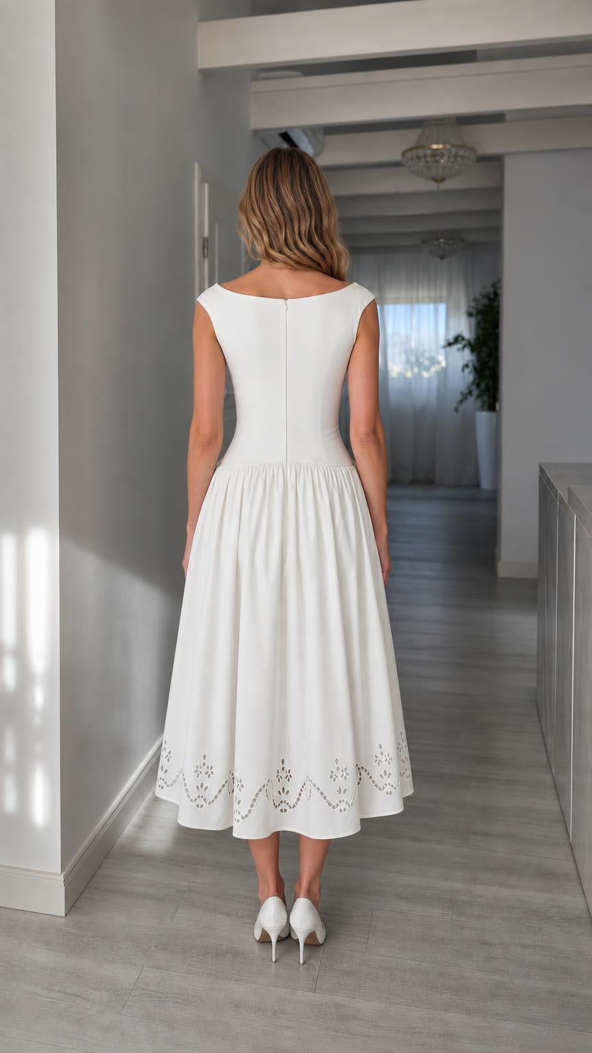 Back view of woman wearing white embroidered midi dress