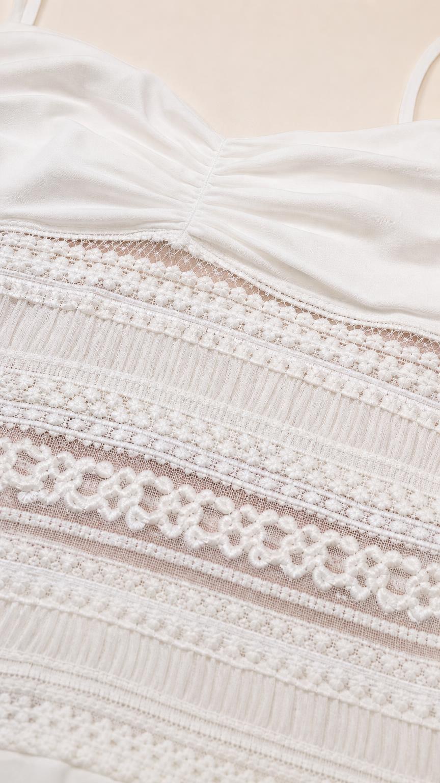 Close-up detail of lace midsection and ruched bodice