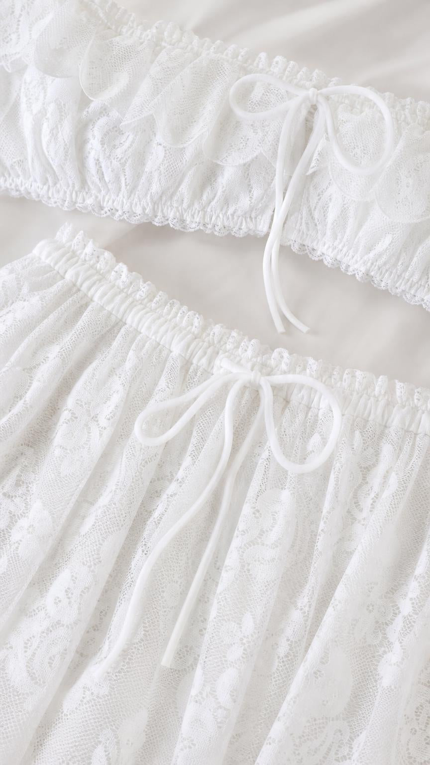 Close-up detail of white lace crop top and skirt drawstring