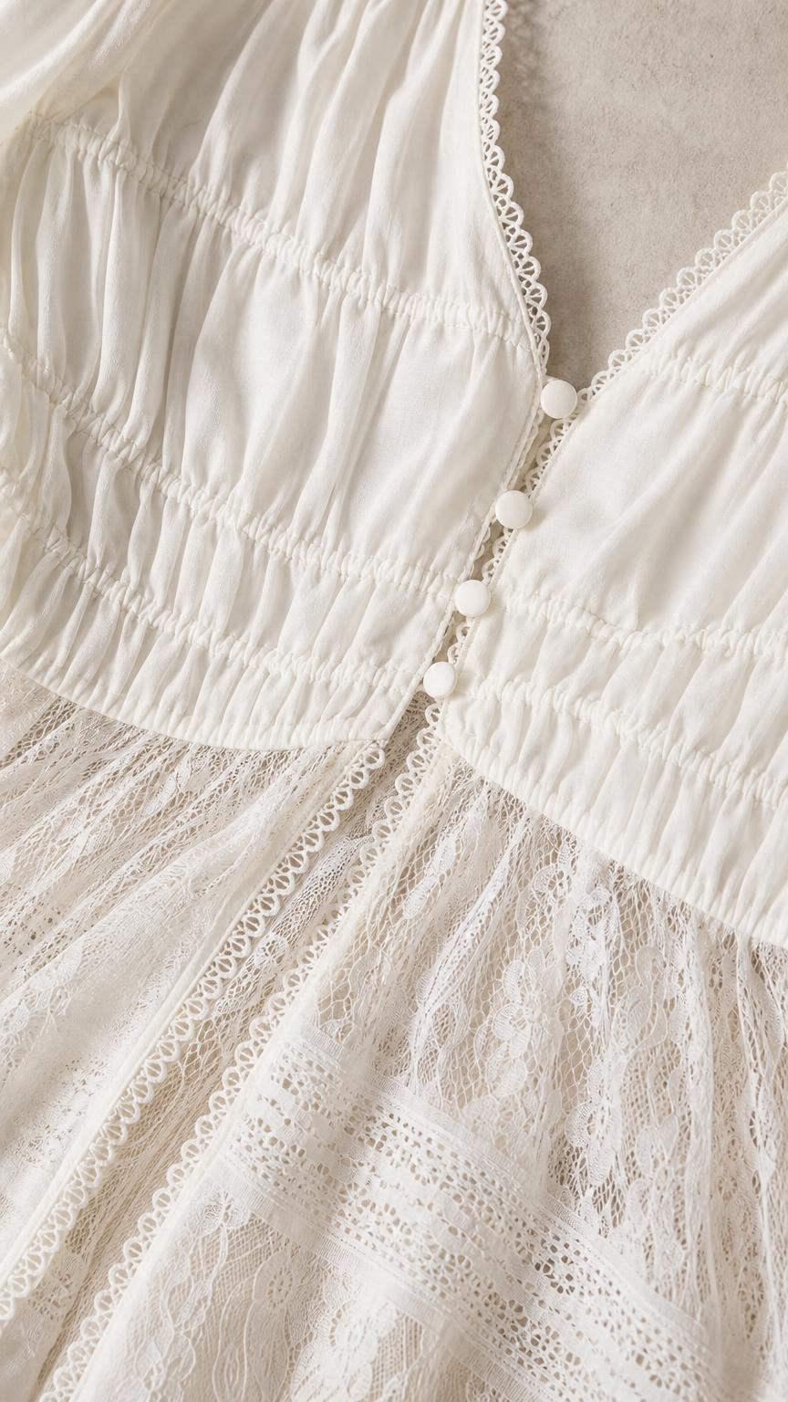 Close up of bodice, buttons, and lace detail on white top