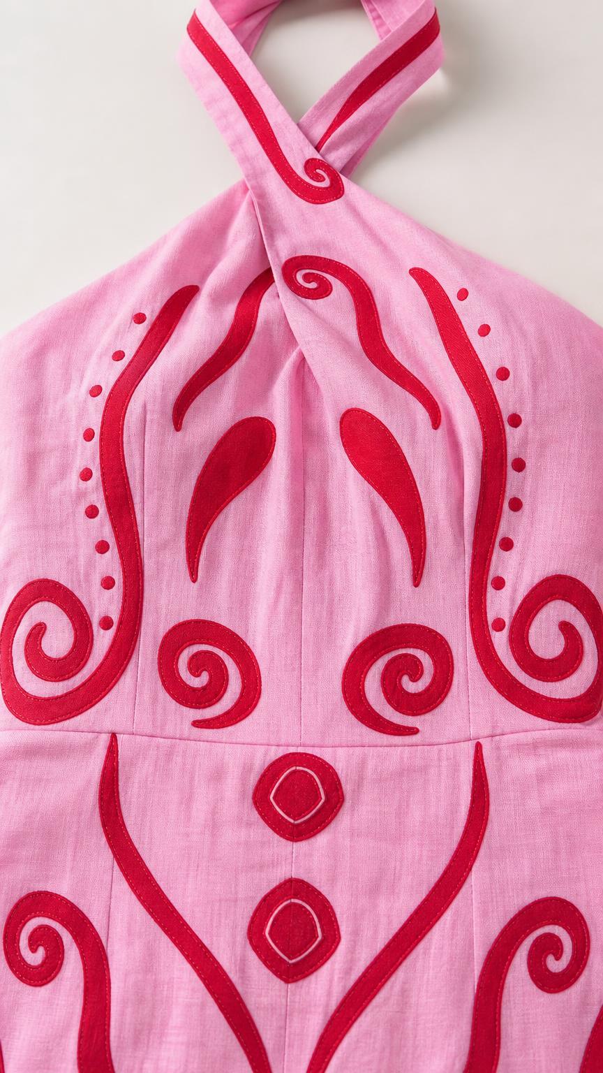 Close-up of the twist-front halter neckline and abstract print