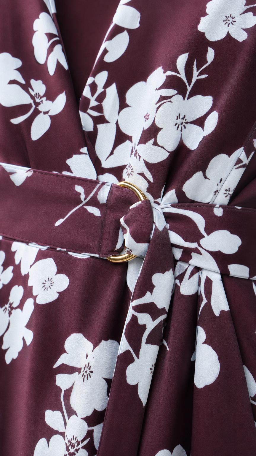 Close-up of burgundy floral fabric and gold-tone ring waist detail