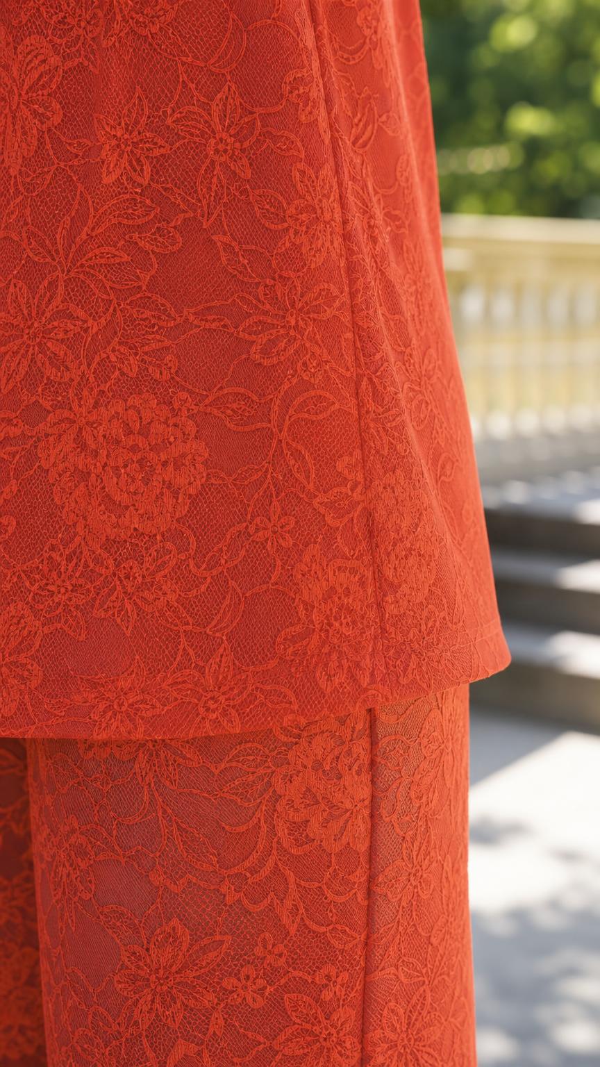 Close-up detail of rust red floral lace texture