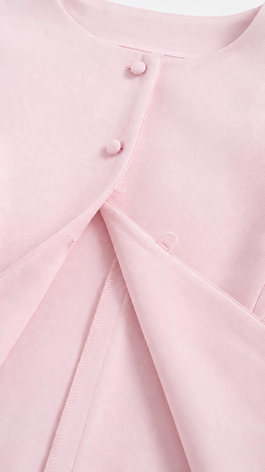 Close-up of pink top buttons and fabric detail