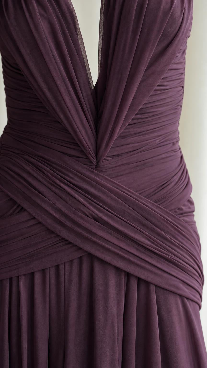 Close up of pleated bodice and crossover waist detail in plum