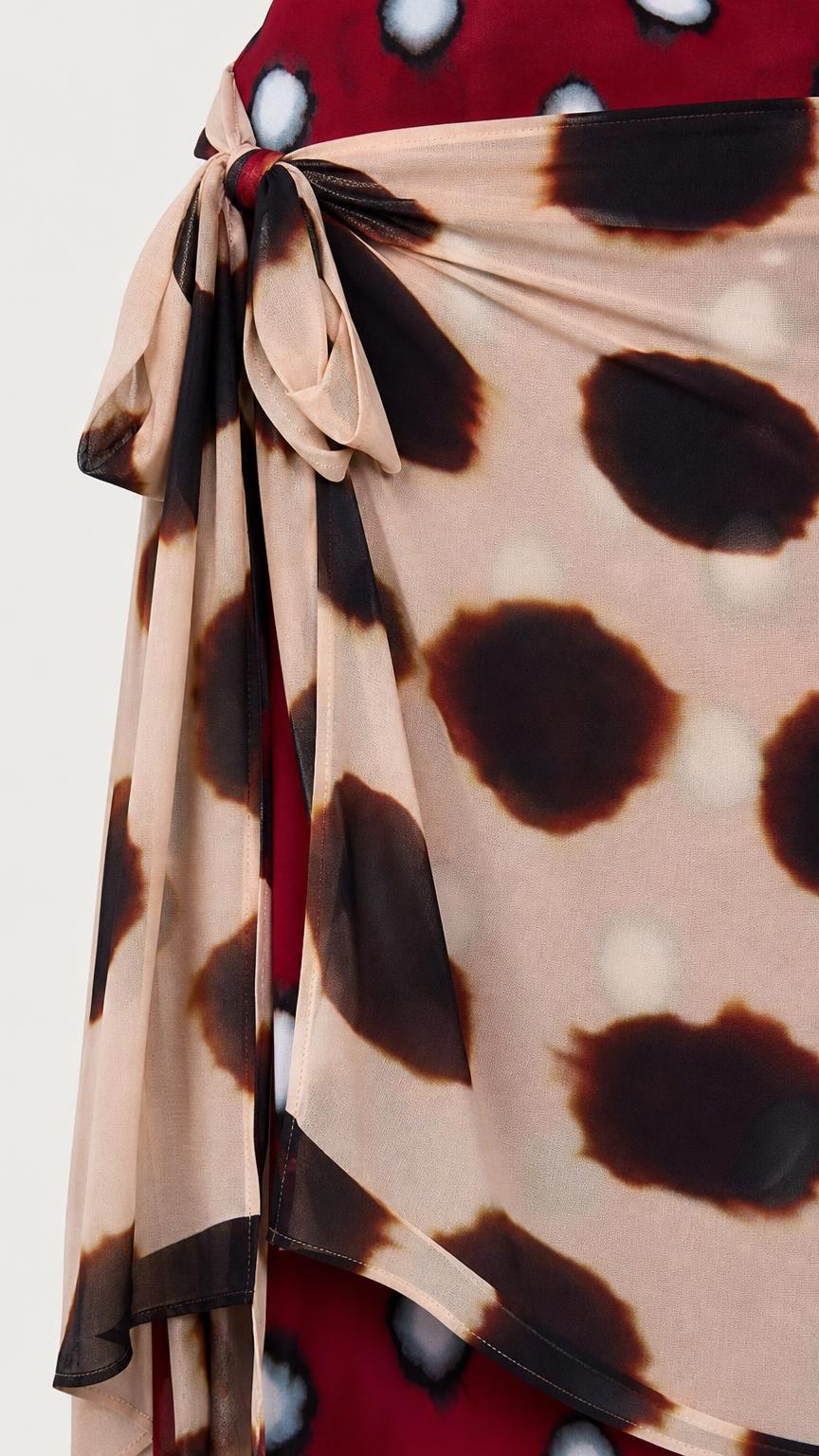 Close-up detail of side tie and polka dot fabric pattern