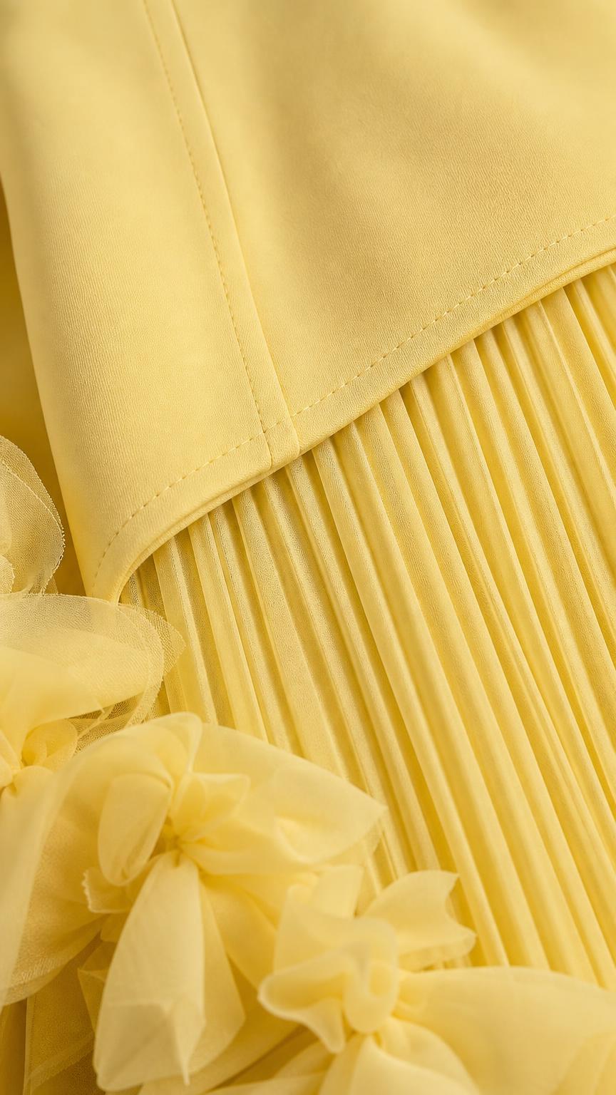 Close-up detail of pleated skirt and ruffle hem