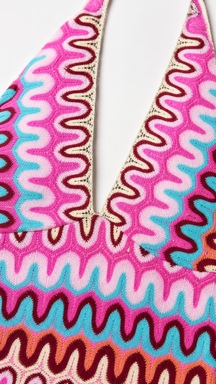 Close up of neckline and knit texture on pink multi dress