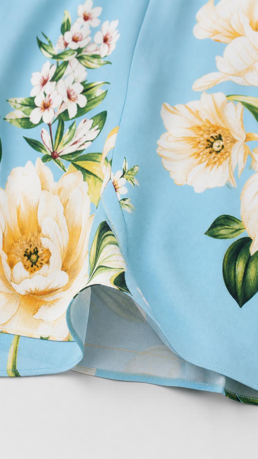 Close-up detail of yellow and white floral print and fabric hem