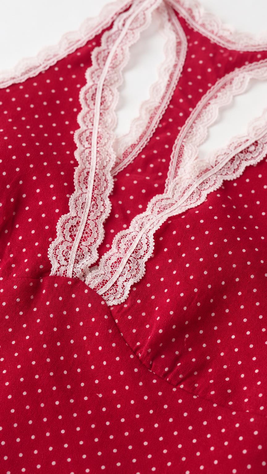 Close-up of lace trim detail on the red polka dot dress